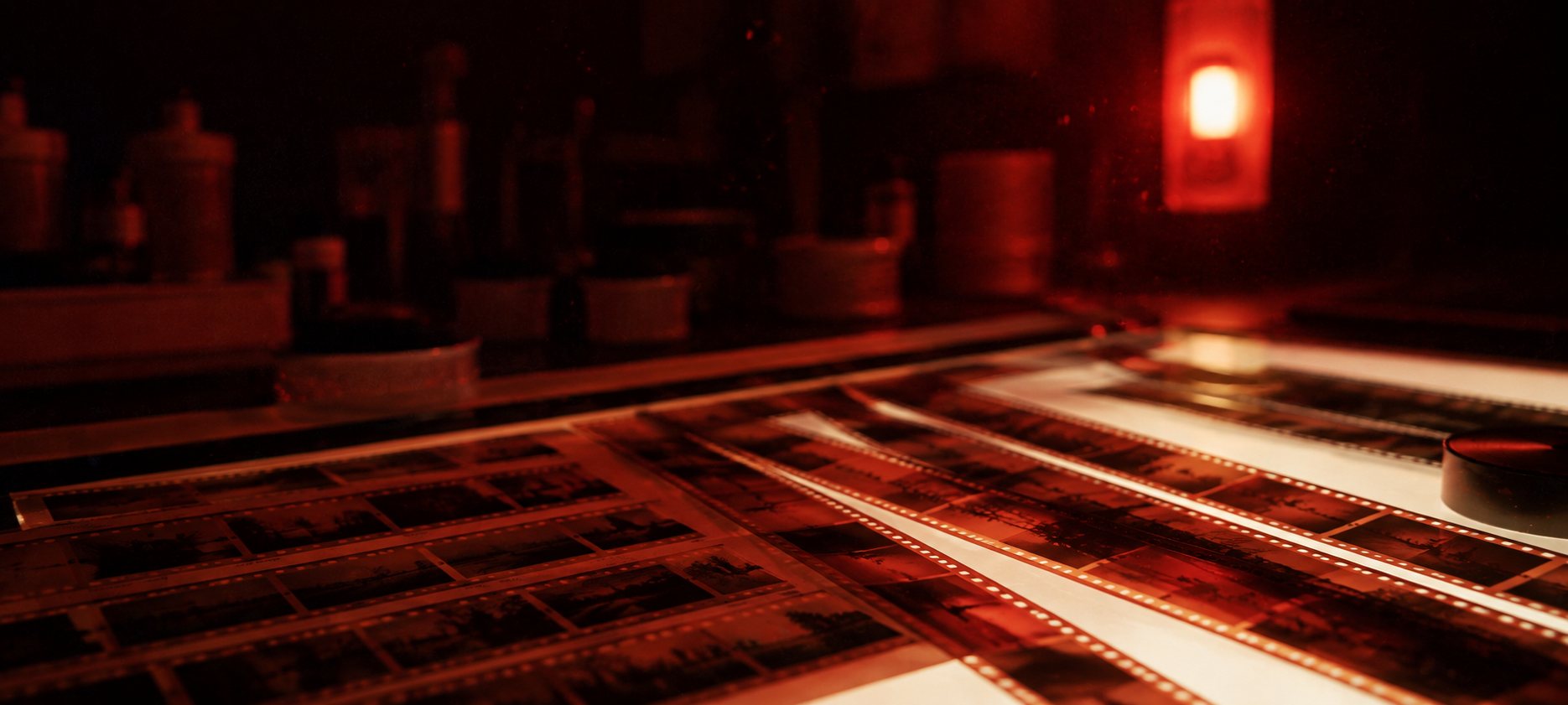 Developed contact sheets and negatives on a light table at Isla Film Lab